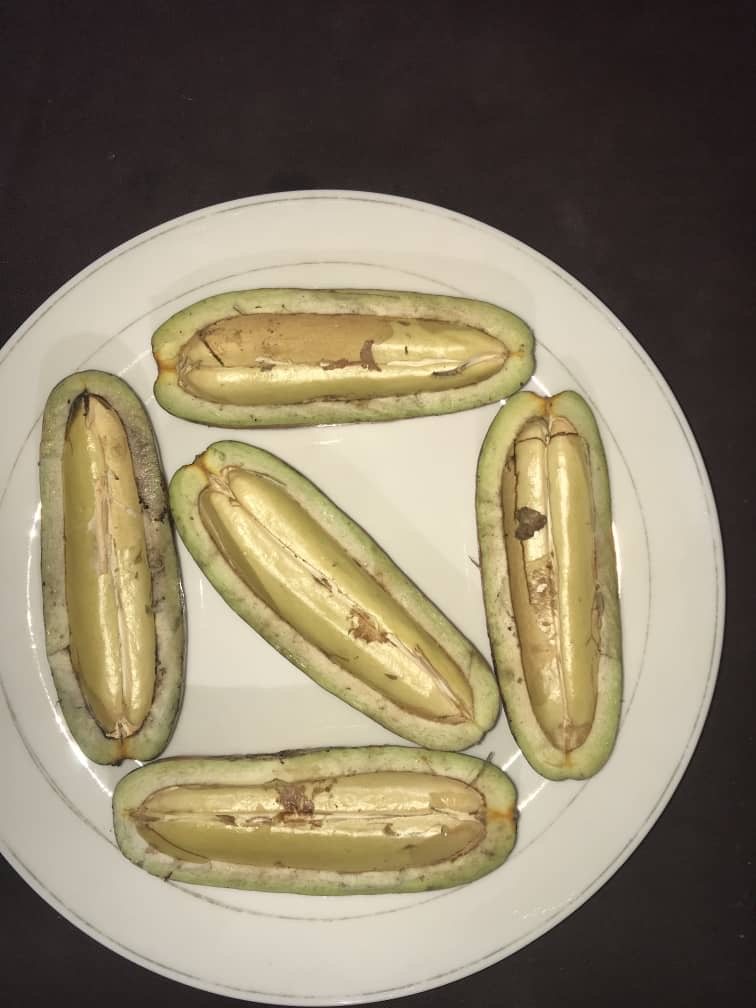 Five safou fruits halved on a plate, pale flesh around a single stone, photograph supplied by the farm